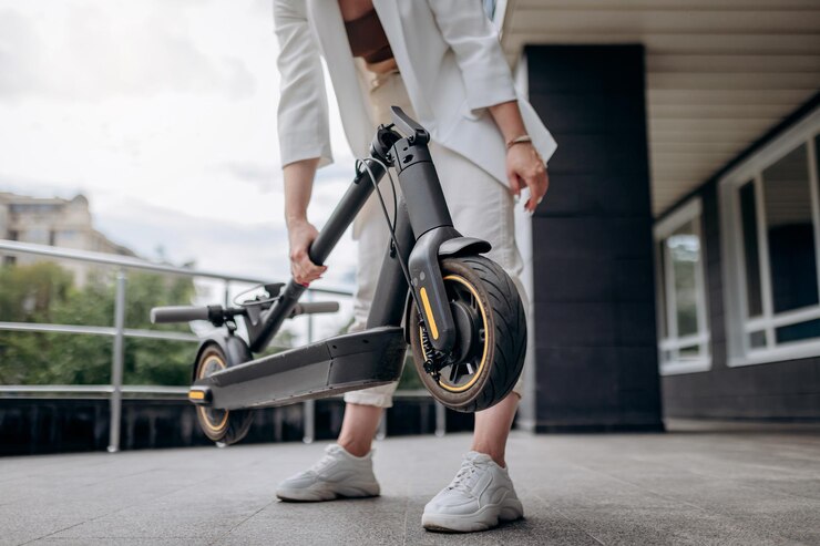 close up woman white suit folding her electro scooter after ride while standing background modern building 194143 10114 close up woman white suit folding her electro scooter after ride while standing background modern building 194143 10114