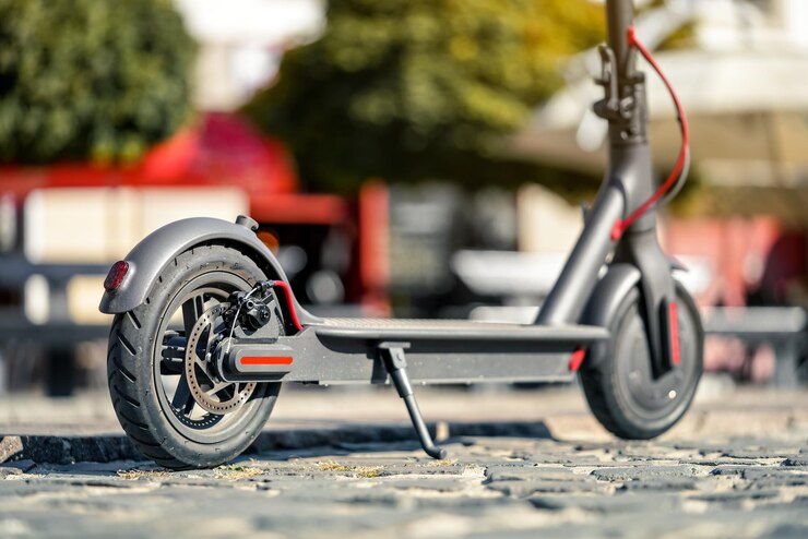 electric scooter parked tiled cobblestone pavement closeup detail rear wheel with disc brake 692357 7794 electric scooter parked tiled cobblestone pavement closeup detail rear wheel with disc brake 692357 7794